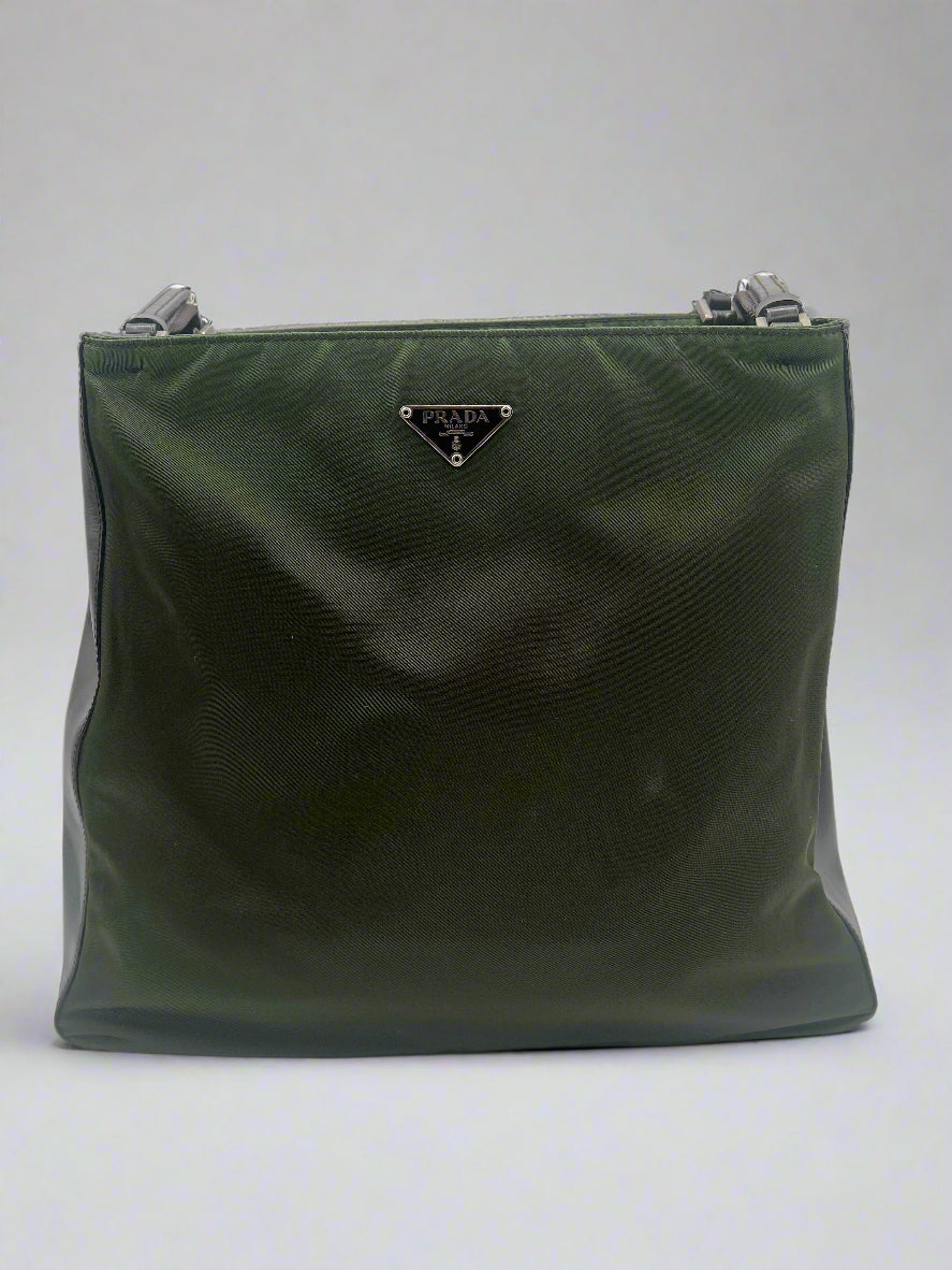 Green clutch bag with a brand logo on a white background