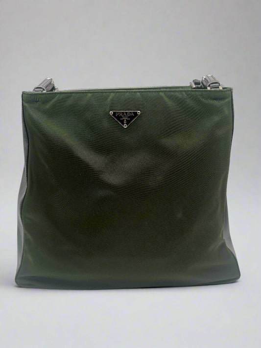 Green clutch bag with a brand logo on a white background