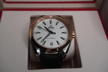 Omega watch with white face and black leather strap on a reflective surface