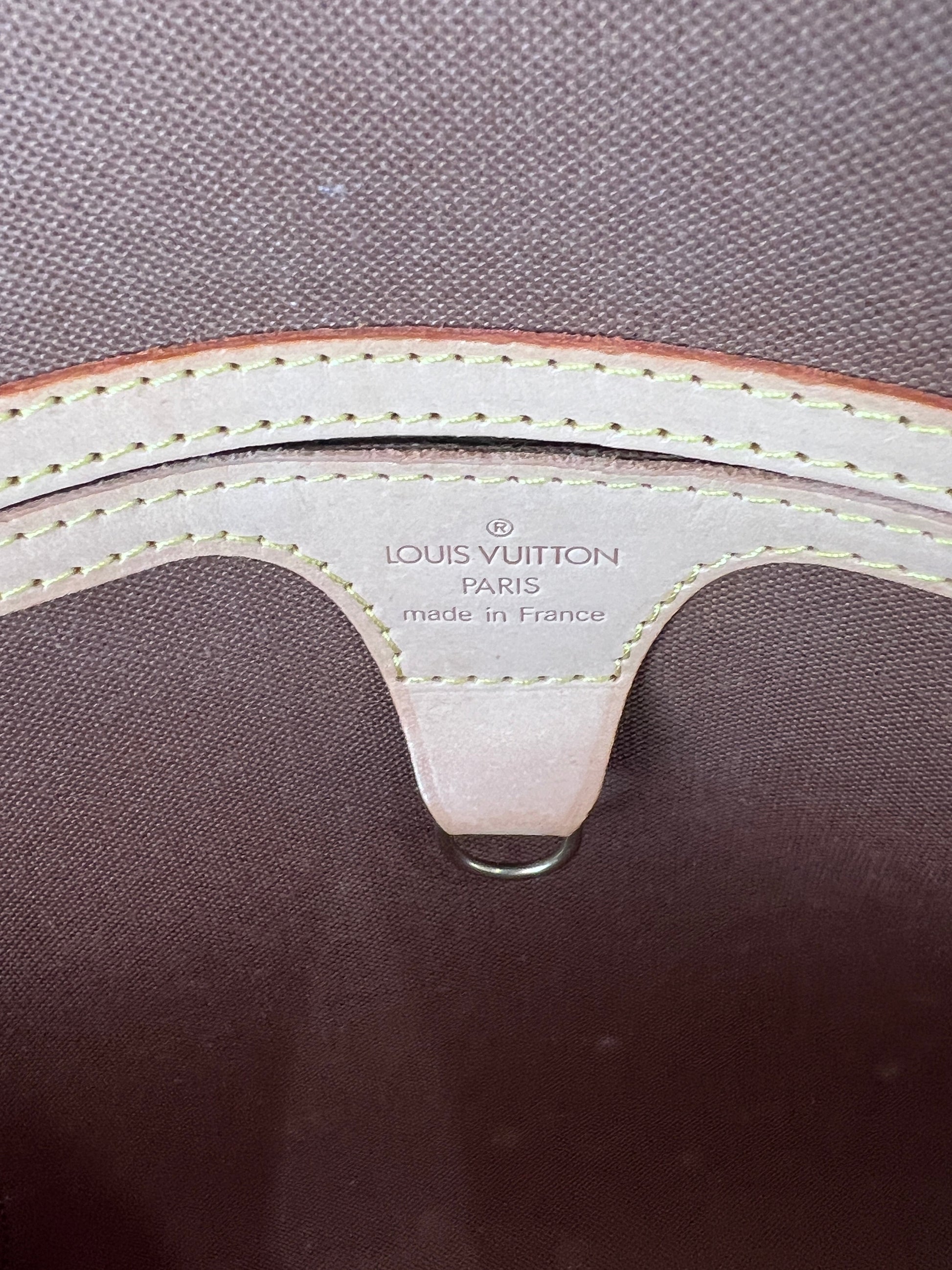 Close-up of a Louis Vuitton bag with visible branding and stitching detail.